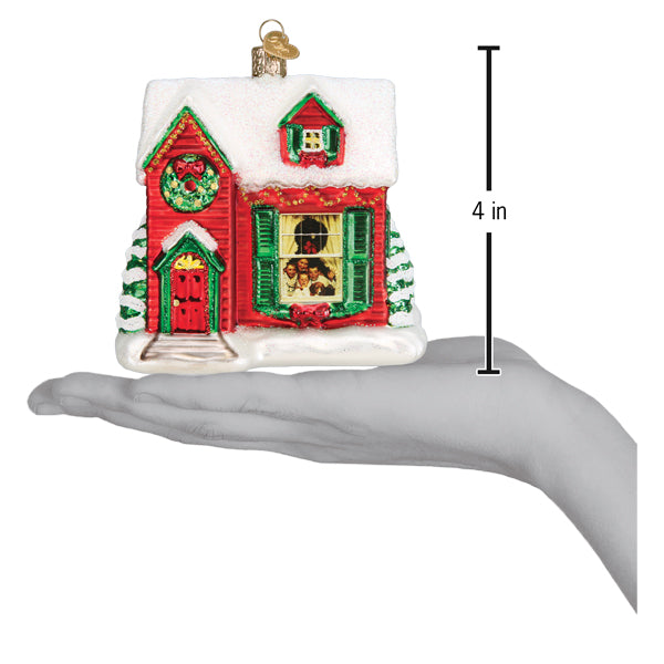 Norman Rockwell You're Home! glass house ornament shown in hand for scale, measuring 4 inches tall.