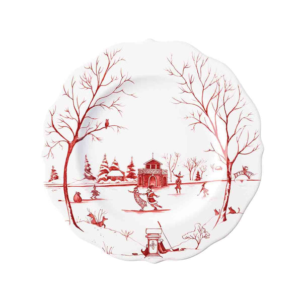 Scalloped ceramic plate with red winter scene of ice skaters, bare trees, and a gazebo.