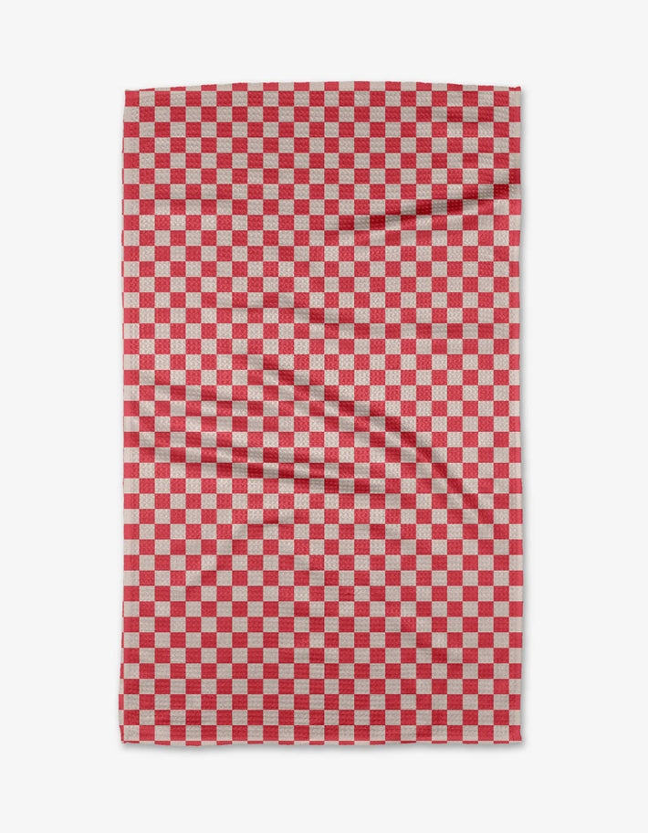 Holiday tea towel with waffle weave construction in red featuring a festive snowflake pattern.