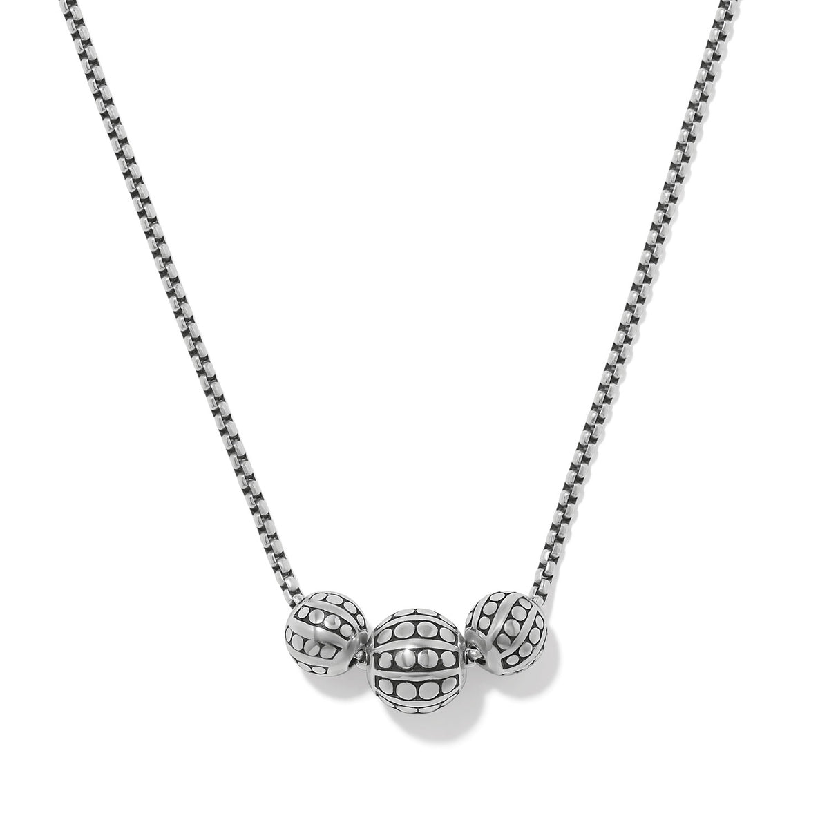 Pebble Dot Bola Trio Necklace featuring three patterned silver beads on a box chain.