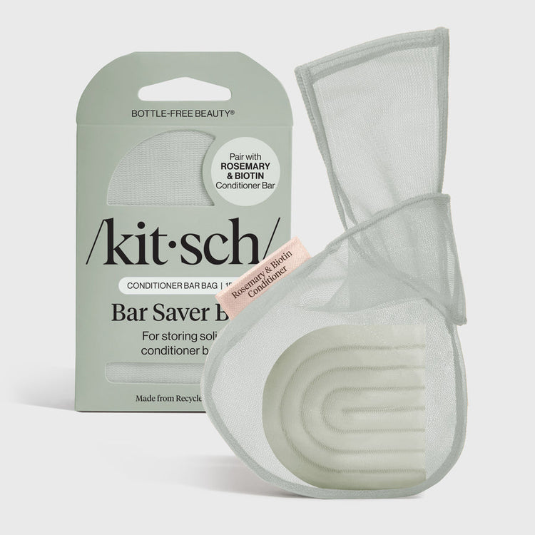 Recycled rPET mesh saver bag holding a Rosemary & Biotin conditioner bar.