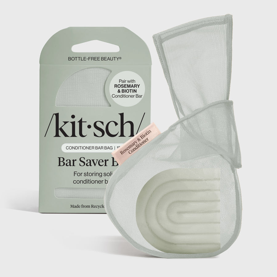 Recycled rPET mesh saver bag holding a Rosemary & Biotin conditioner bar.