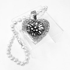Fashion pearl necklace featuring an intricate heart-shaped pendant locket on a silver-toned chain.
