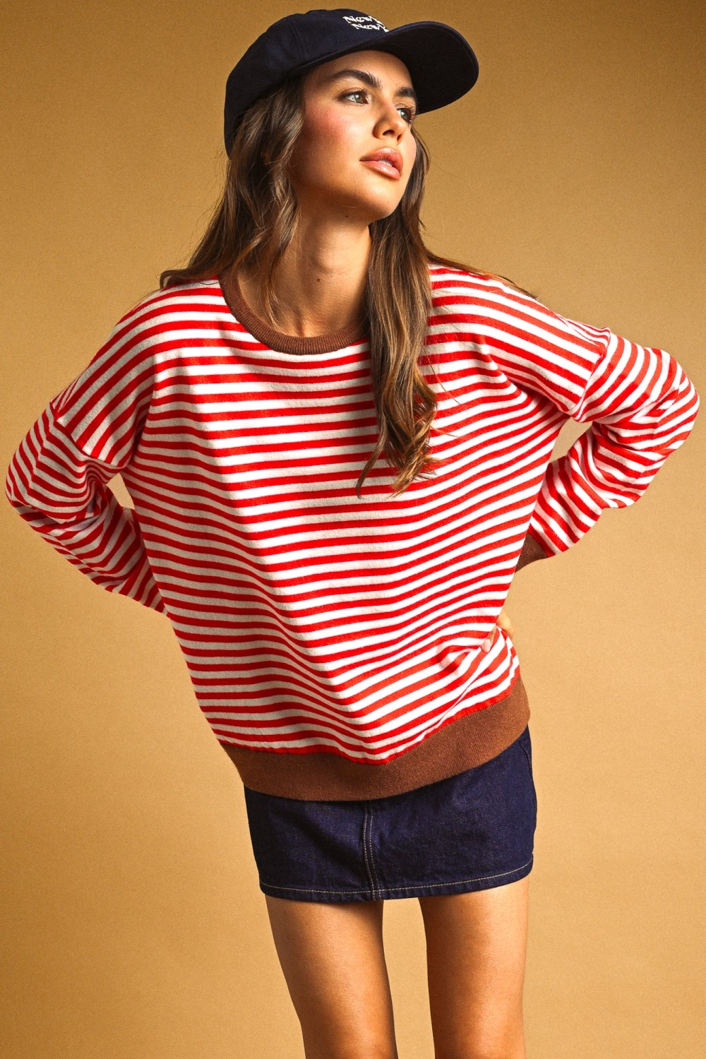 Woman in Alessia Striped Multi Color Contrast Knit Top with red and white stripes and brown trim.