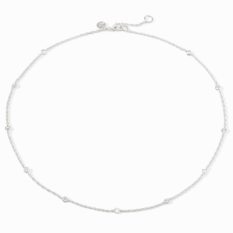 Silver station necklace with small round cubic zirconia stones and an adjustable lobster clasp.