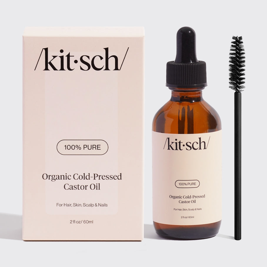 Bottle of USDA organic castor oil with a white label against a neutral background.