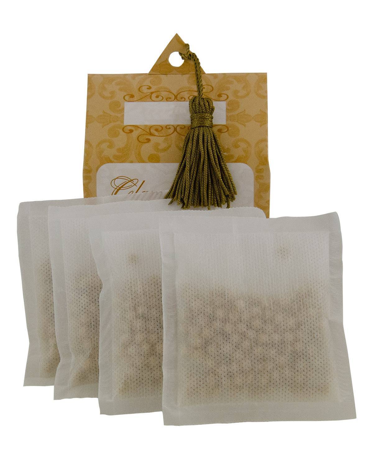 Four white mesh Glamorous Sachets in front of a decorative gold patterned card with a green tassel.