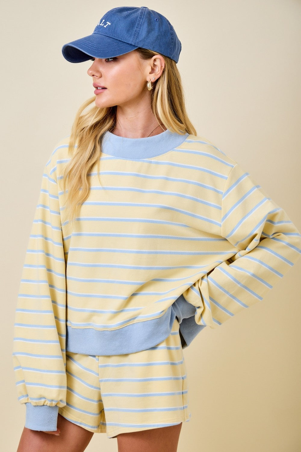 Woman wearing the Elizabeth Mockneck Stripe Sweatshirt Lounge Top in yellow and blue stripes.