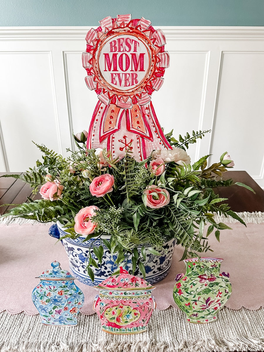 Beck's Best Mom Ever ribbon stake with red background, white text, and gold glitter accents.