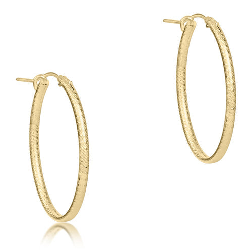 Textured gold-filled oval hoop earring with a notch clasp