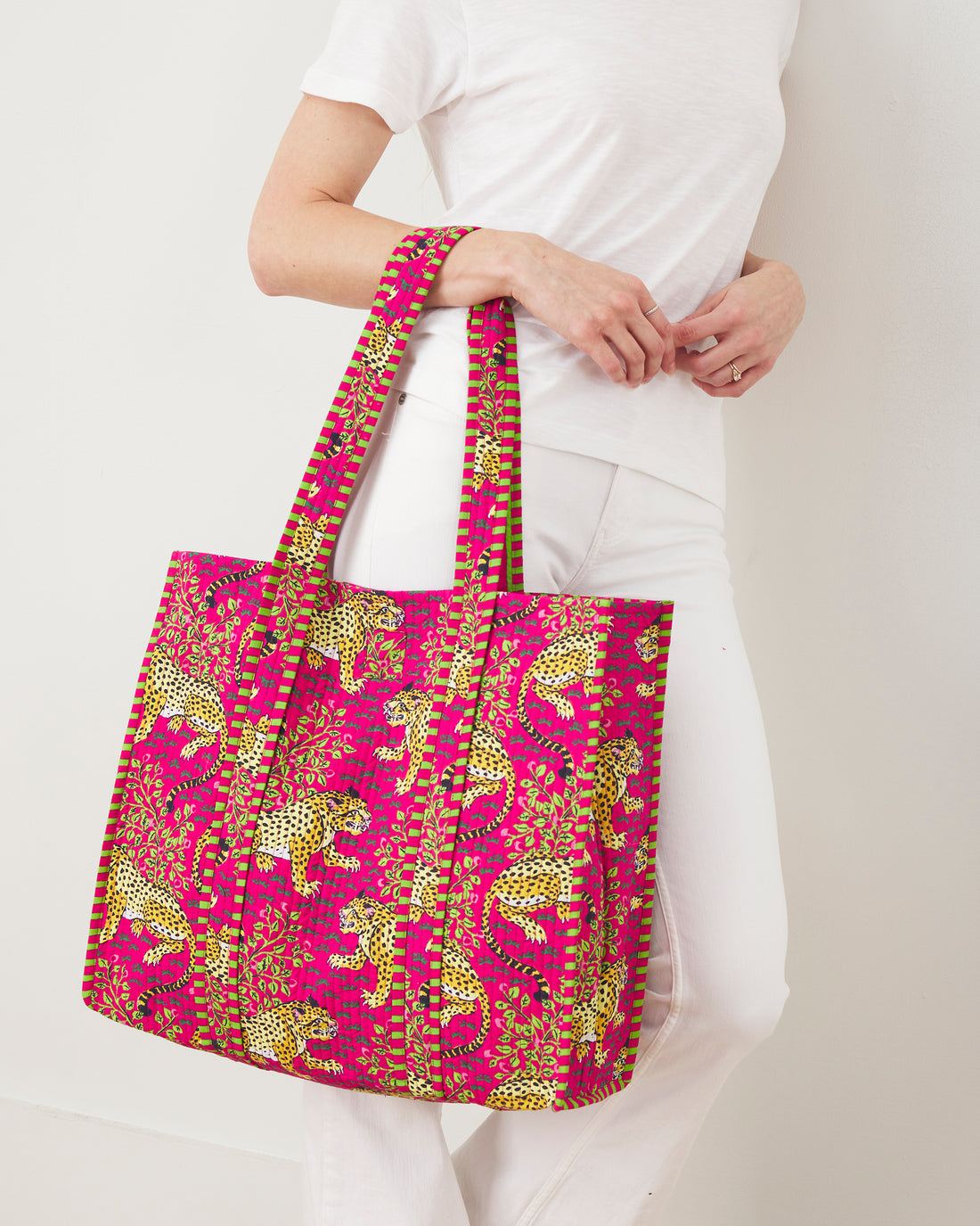 Large pink organic cotton tote bag with a yellow leopard print and green striped straps.