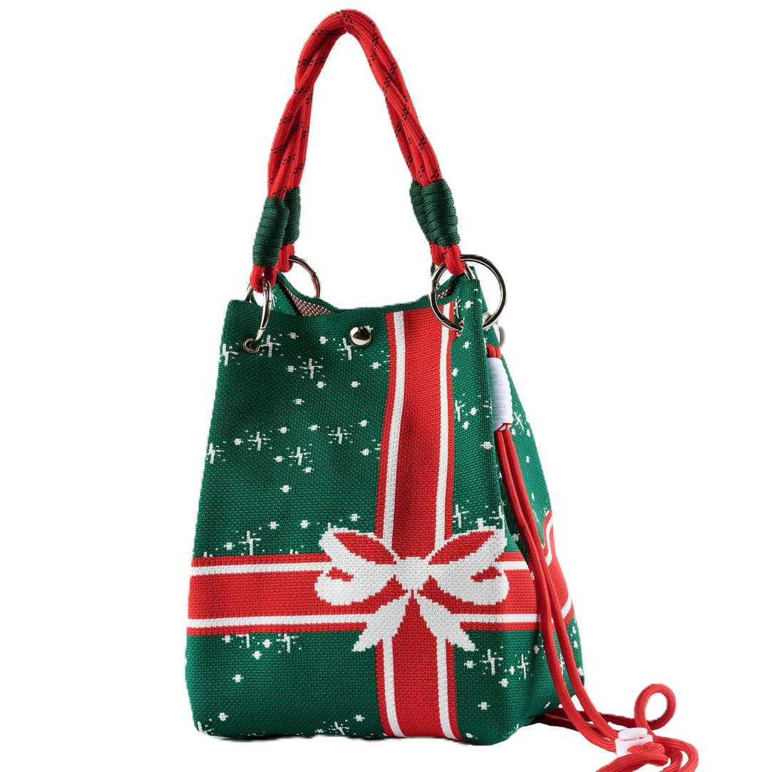 Green and red knit Christmas sweater bucket bag with a white bow and snowflake pattern.
