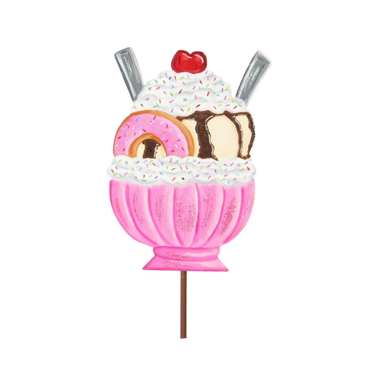 Pink ice cream sundae stake with a donut, cherry, and sprinkles.