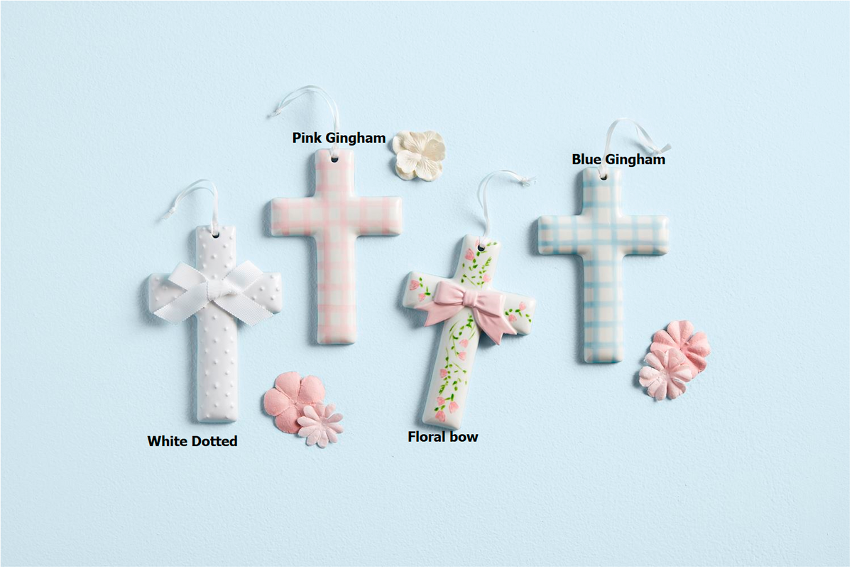 Four ceramic crosses in white dotted, pink gingham, floral bow, and blue gingham designs.