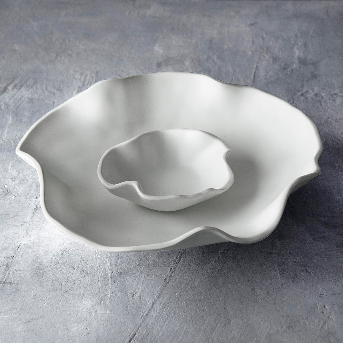 White melamine chip and dip set with two bowls on a stand.