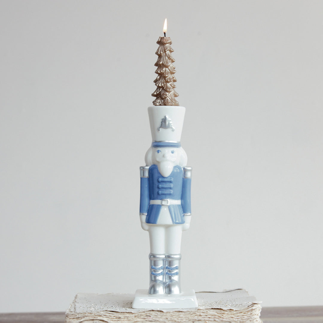 White and blue ceramic nutcracker taper candle holder with silver electroplating details.