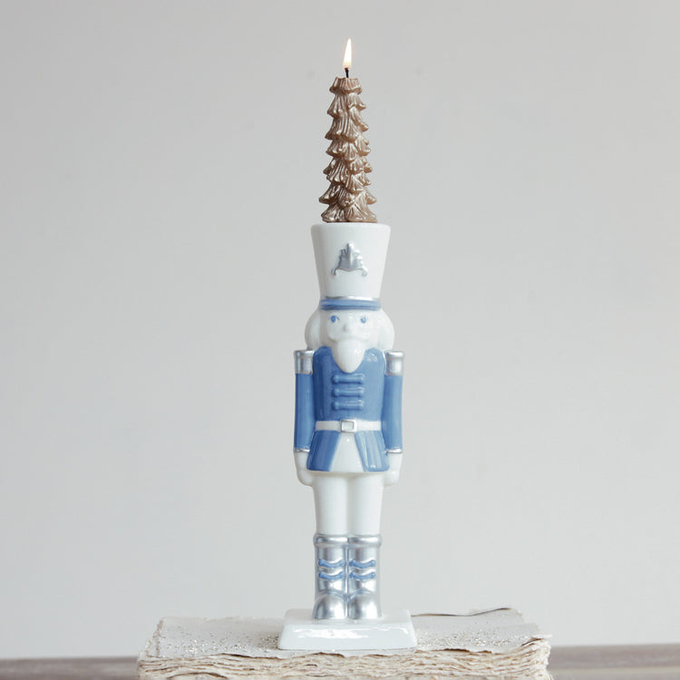 White and blue ceramic nutcracker taper candle holder with silver electroplating details.