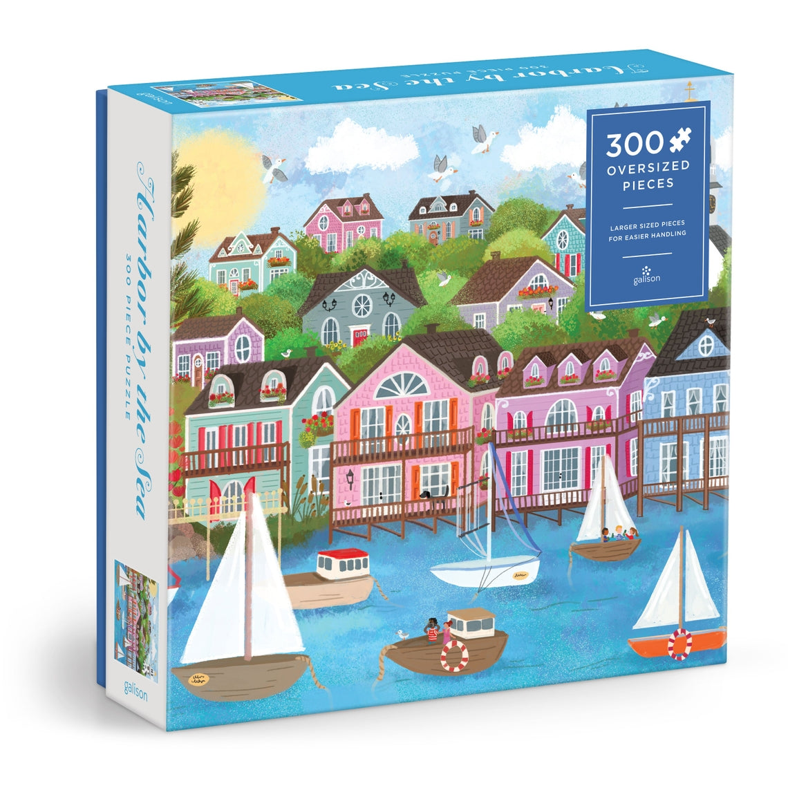 Joy Laforme Harbor By the Sea puzzle box showing a coastal scene with blue water and sandy shore.