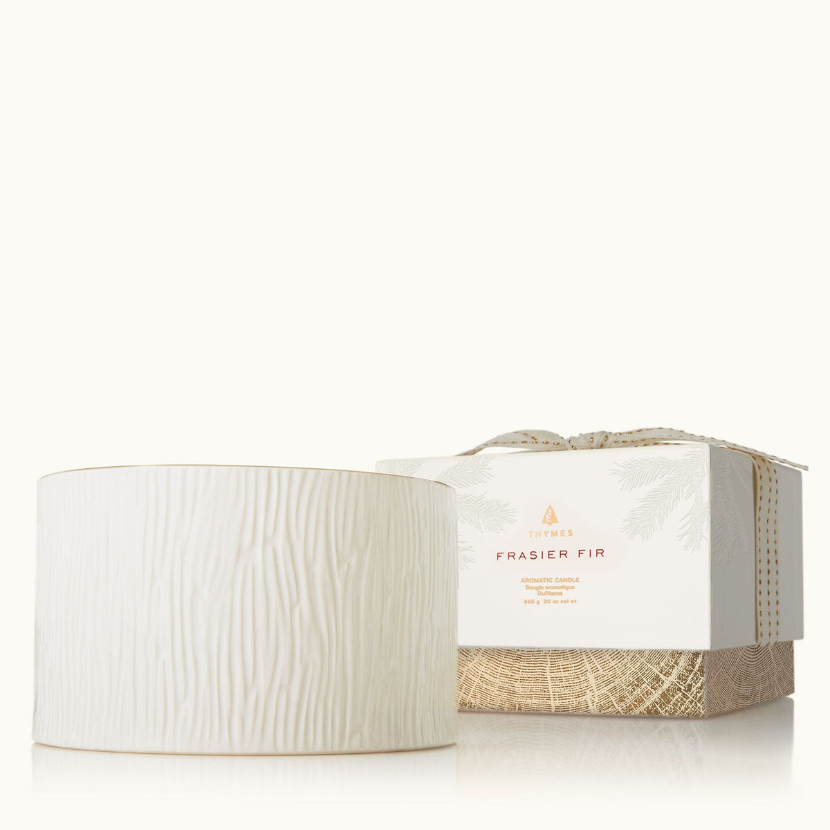 Frasier Fir 3-wick ceramic poured candle in a white woodgrain vessel next to its gift box.