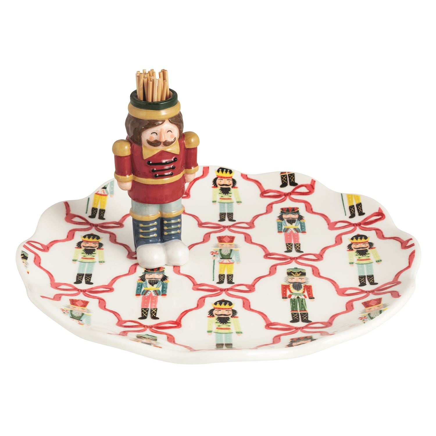 Nutcracker toothpick holder caddy on a matching patterned ceramic appetizer plate.