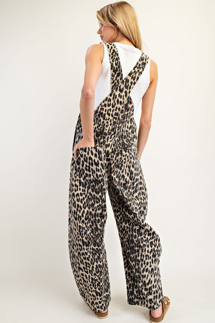 Back view of a woman wearing Denise Leopard Printed Barrel Leg Overalls with a white tank top.