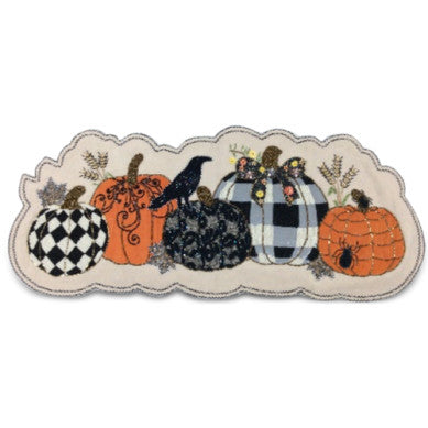 Embroidered table runner featuring five decorative pumpkins, a black crow, and a spider.