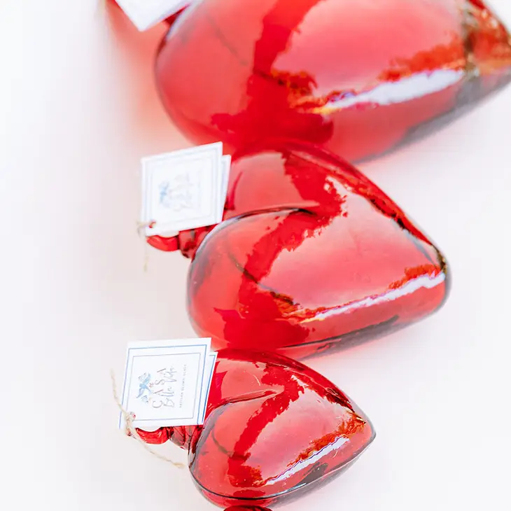 Hand-blown glass heart pendant in clear recycled glass with a smooth organic silhouette.