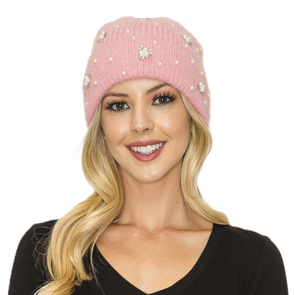 Black knit beanie with fluffy pom pom top, pearl studs, and ribbed brim.