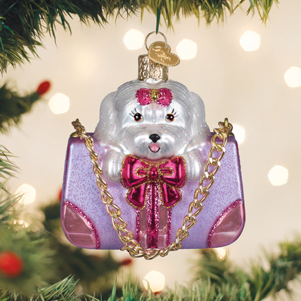 Posh Pup In Purse ornament: a small black dog figurine peeking from an open designer handbag with silver accents.