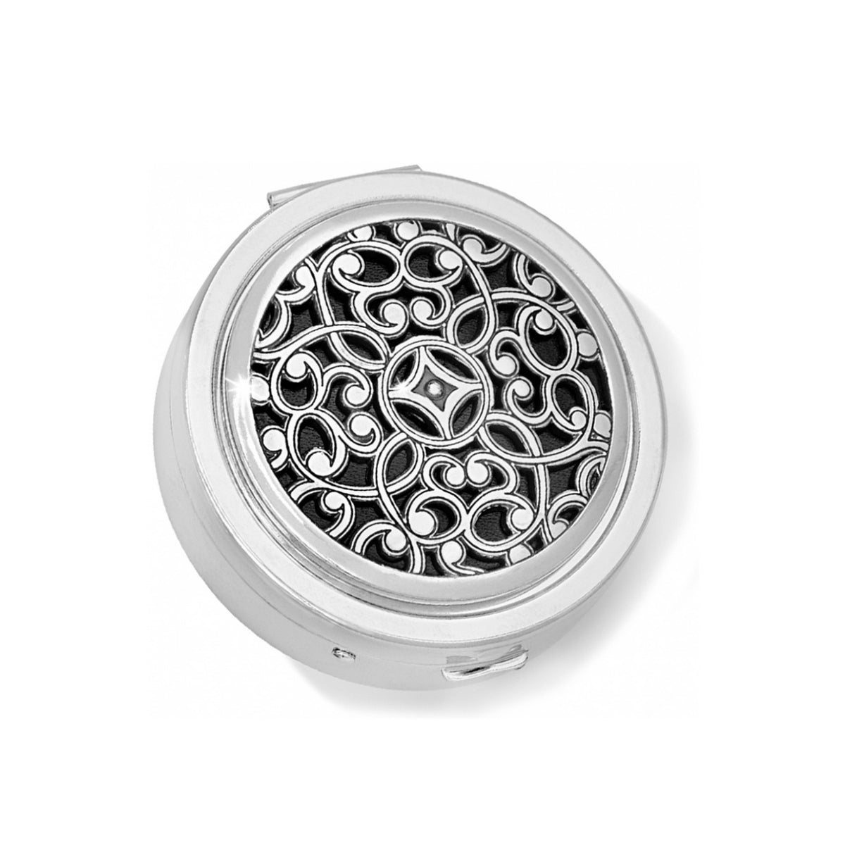 Round silver-plated Serendipity Pill Box with an intricate filigree scrollwork design on the lid.