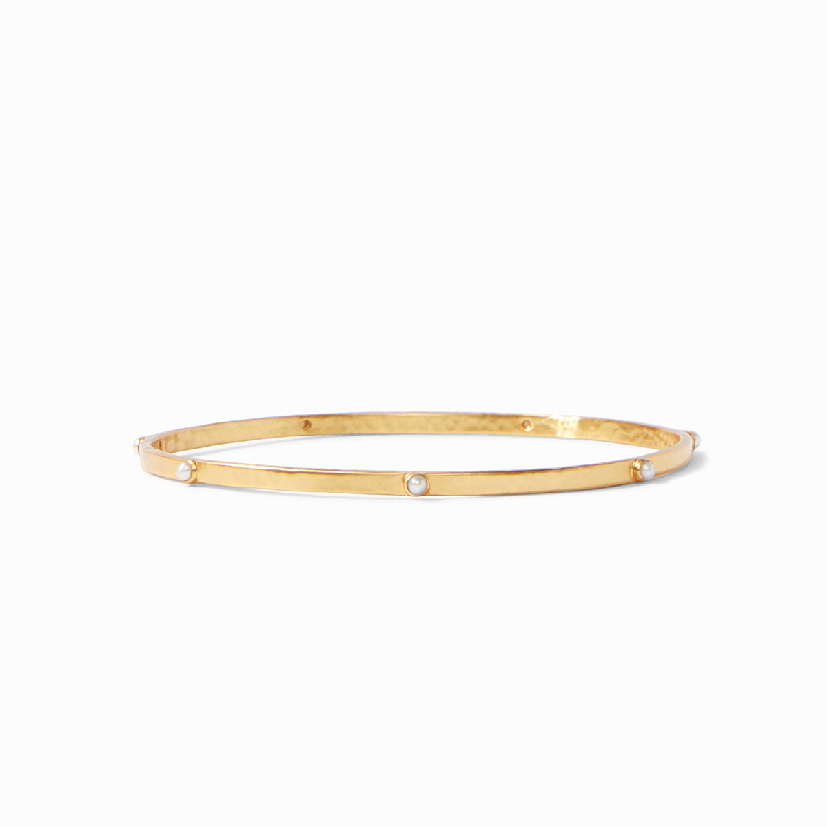 Lightly hammered gold bangle with gemstone stations.