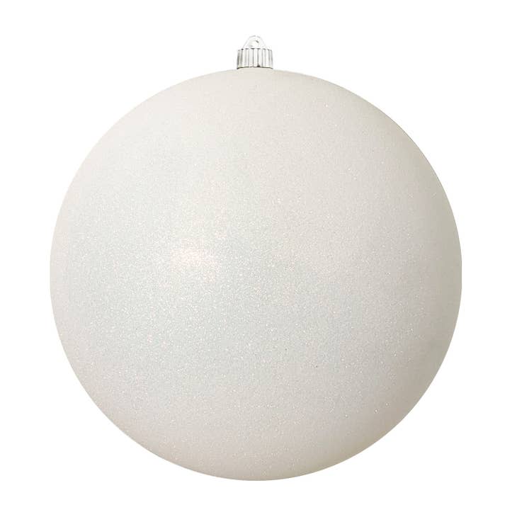 Large white snowflake ornament with glitter finish on a black stand