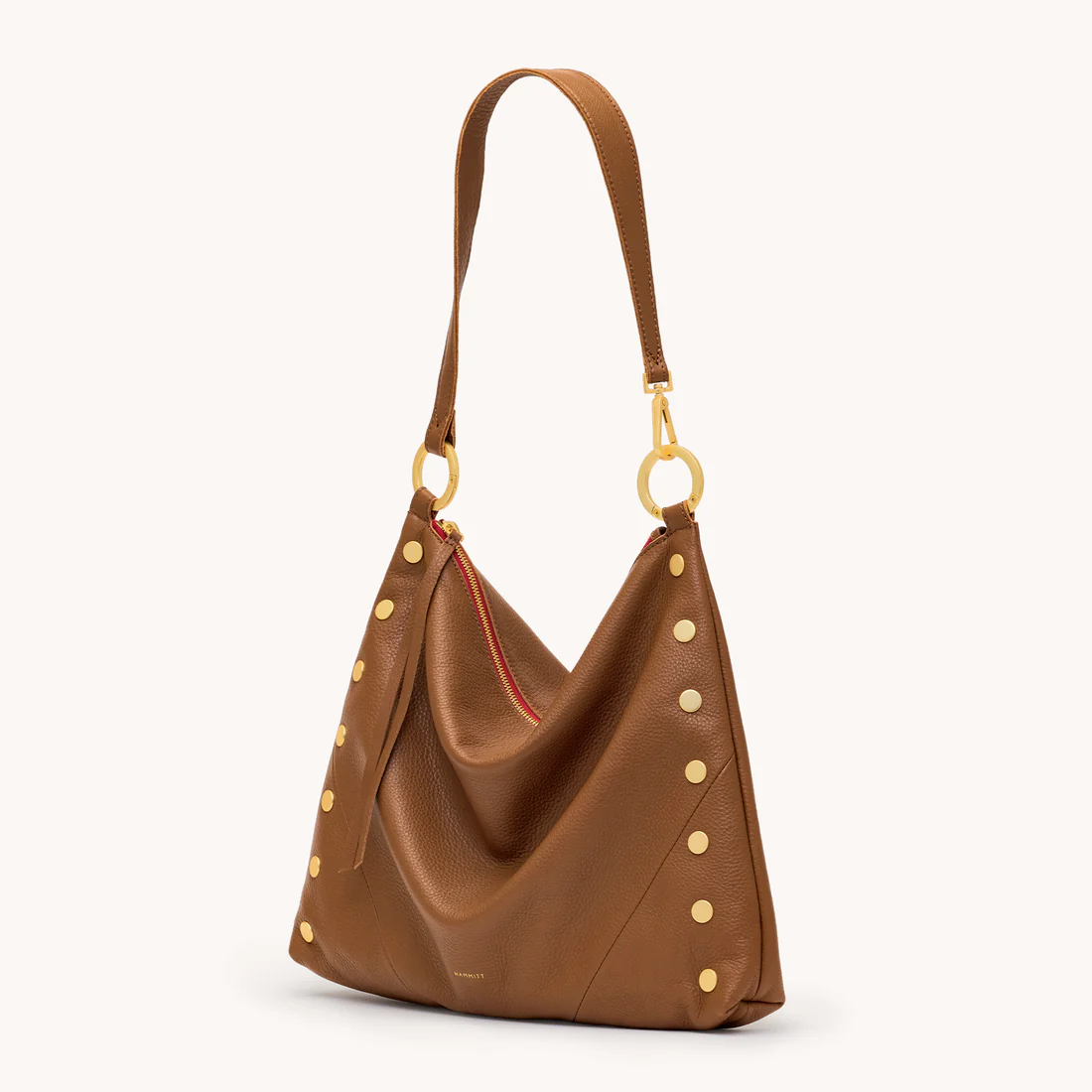 Mahogany pebble leather hobo bag with brushed gold studs, red zipper, and a single shoulder strap.