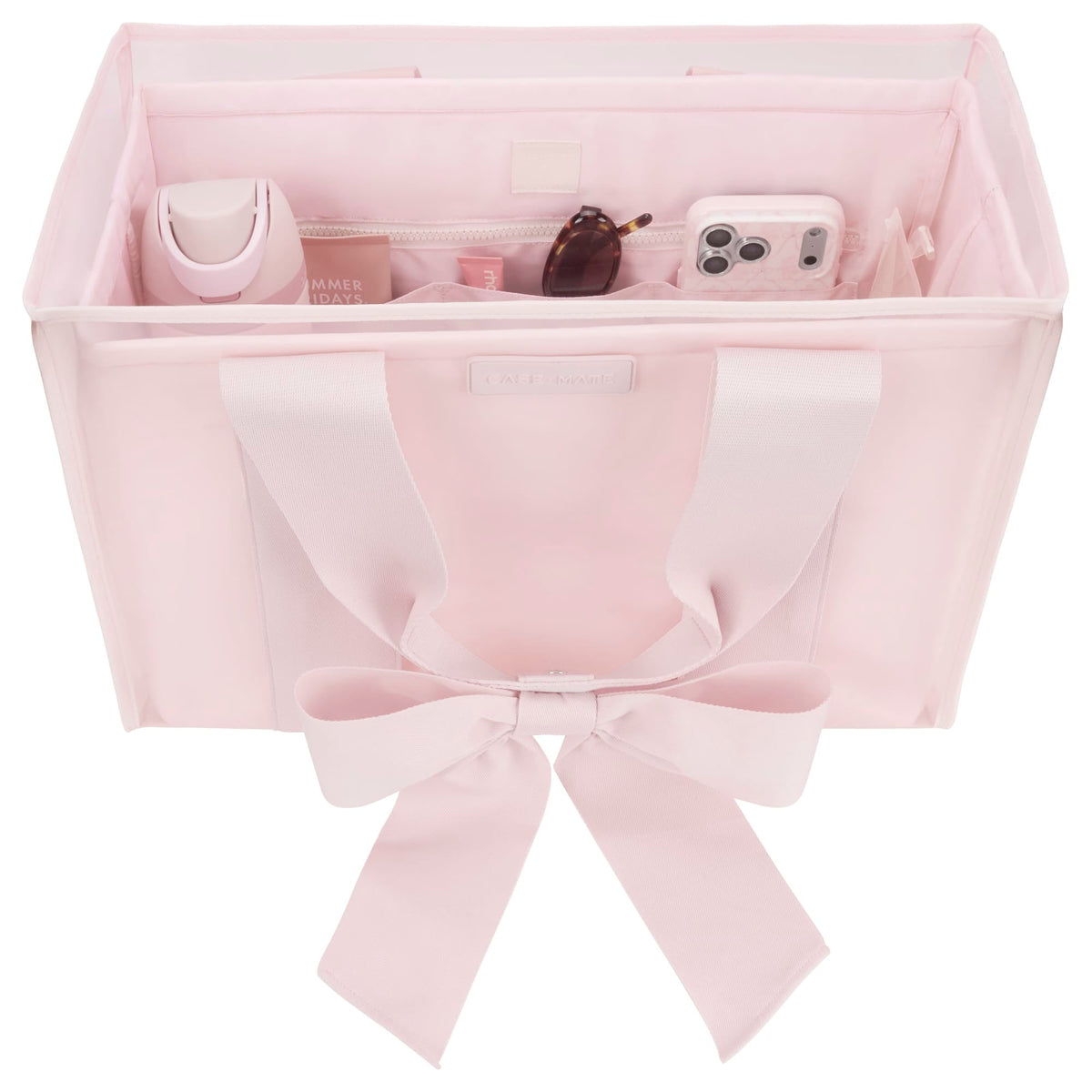 Pink structured tote organizer with compartments holding a water bottle, phone, and sunglasses.