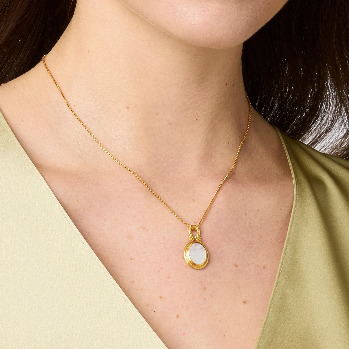 Adjustable 16.5 to 17.5 inch necklace with a mother-of-pearl pendant on gold plate.
