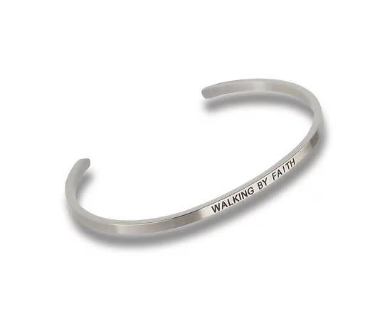 Silver-toned metal cuff bracelet engraved with the words WALKING BY FAITH.