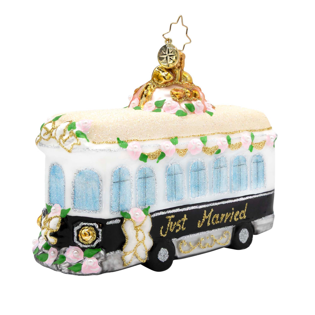 Trolley Of Love glass ornament with pink roses and "Just Married" script on a black and white base.