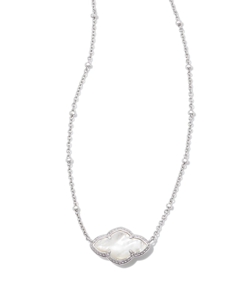 Abbie Pendant Necklace on an elongated chain with a medallion featuring joy and optimism.