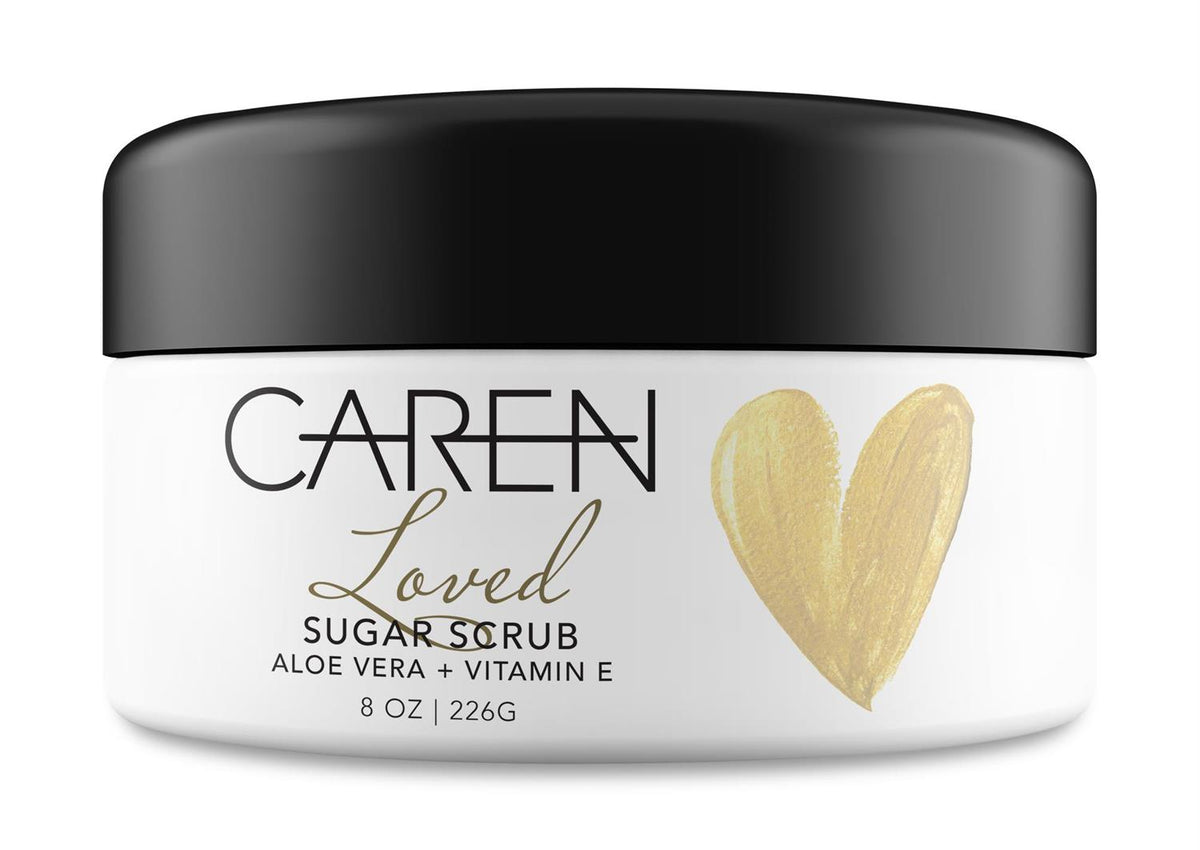 White jar of CAREN Loved Sugar Scrub with aloe vera and vitamin E, featuring a gold heart.