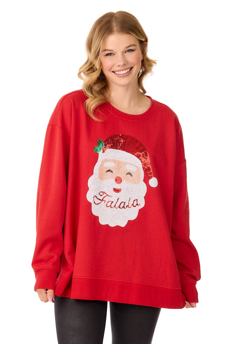 Woman wearing a red Santa Sparkle Sweatshirt with a sequined Santa face and "Falala" text.