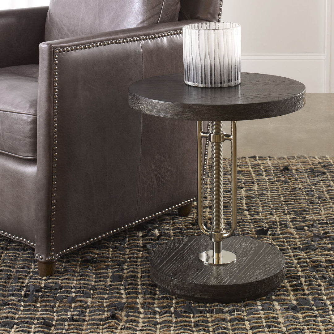 Emilian adjustable accent table with a light wood finish and curved legs.