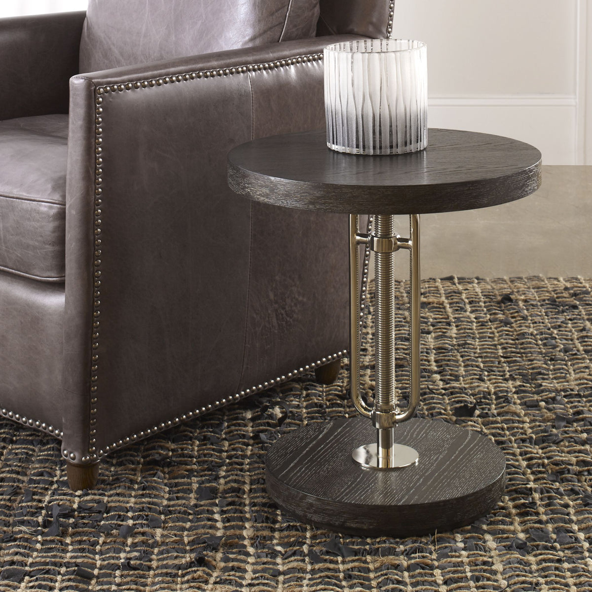 Emilian adjustable accent table with a light wood finish and curved legs.
