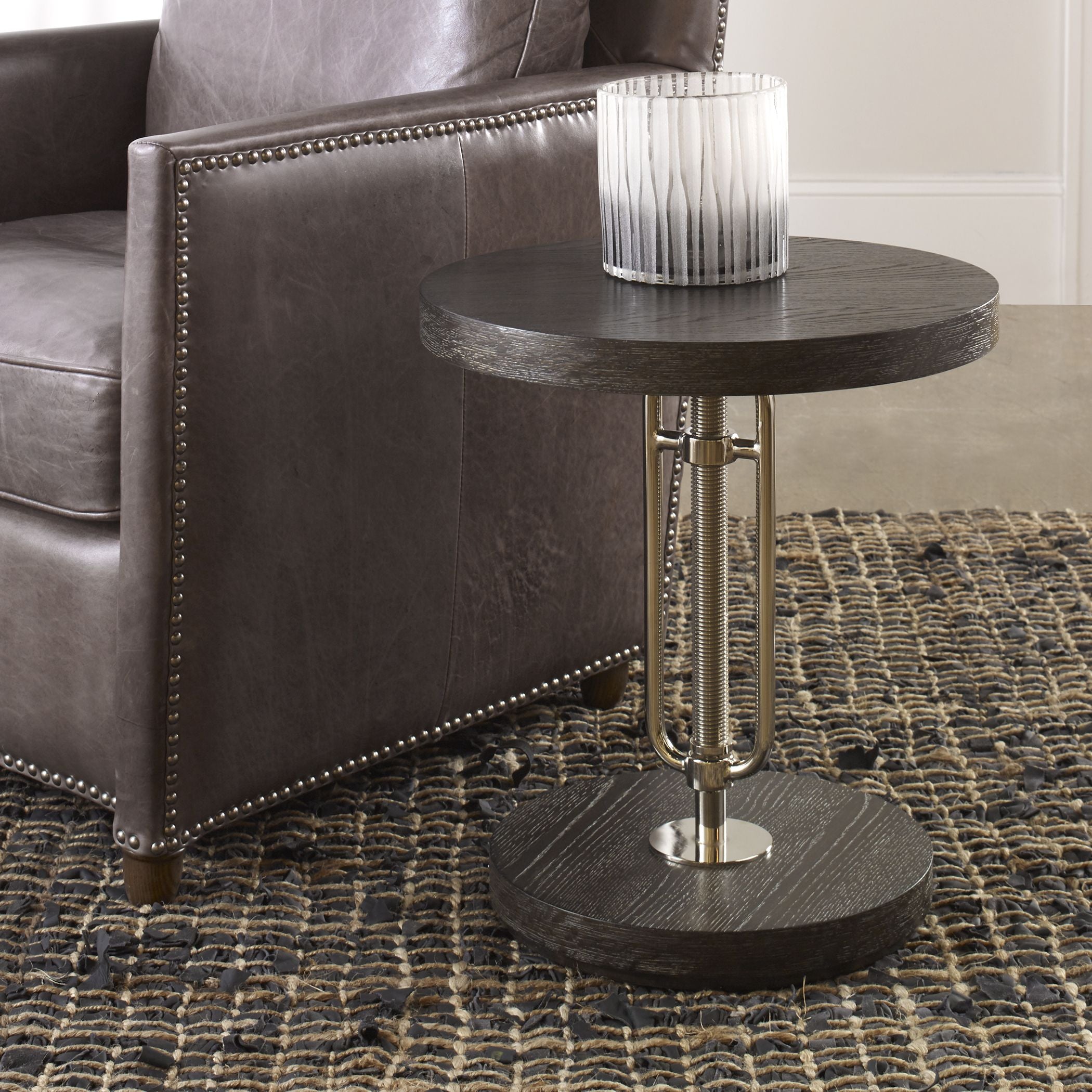 Emilian adjustable accent table with a light wood finish and curved legs.