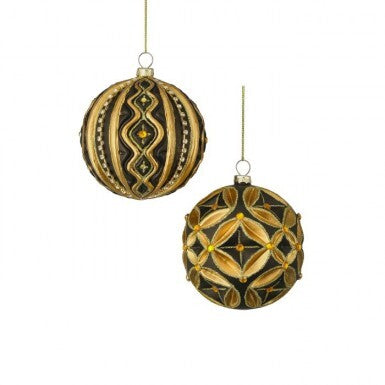 Two 4-inch glass ball ornaments with gold scrollwork and black accents, sold individually.
