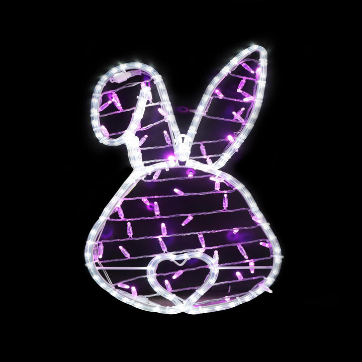 Metal bunny head sign with LED lights in a natural outdoor setting