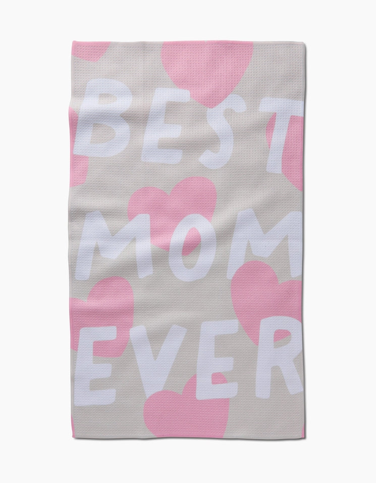 Waffle weave tea towel with pink hearts and white text reading BEST MOM EVER on a beige background.