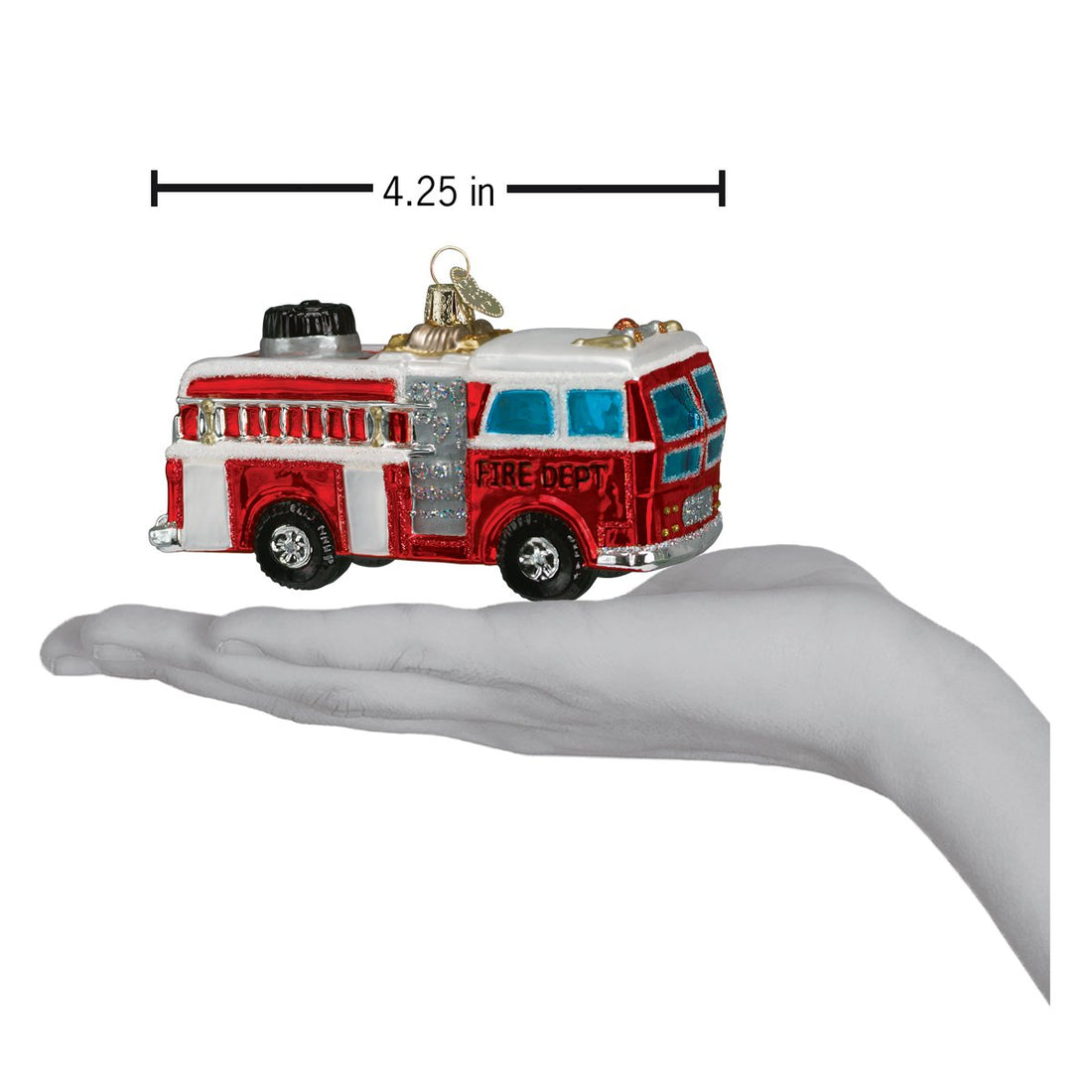 Red and white glass fire truck ornament, 4.25 inches long, held in a hand.