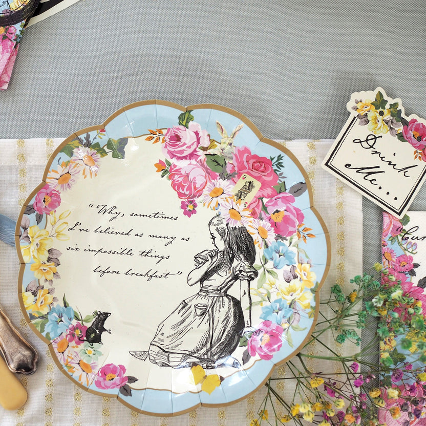 Small white ceramic plate featuring an Alice in Wonderland illustration with a whimsical pattern.