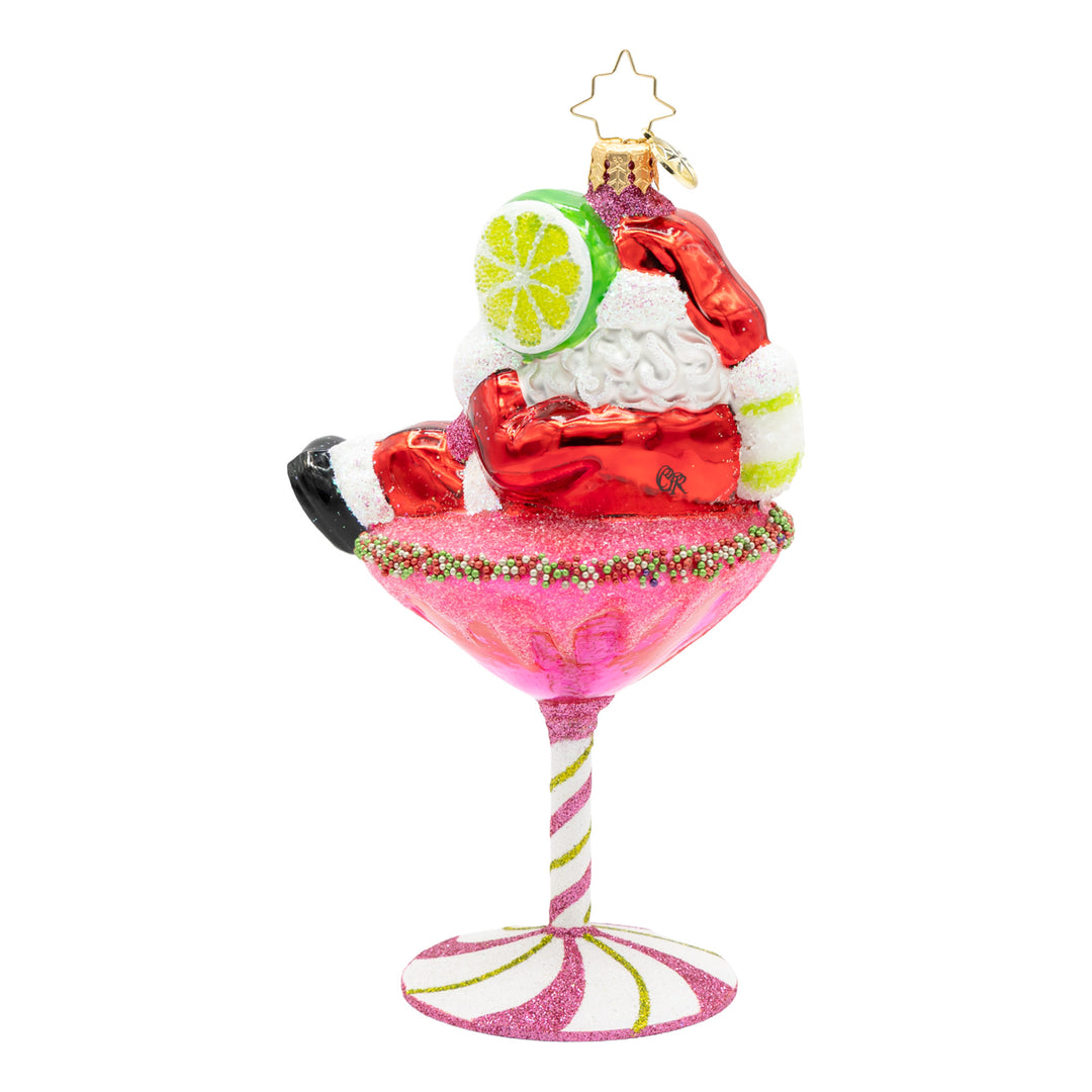 Santa Claus relaxing in a pink cosmopolitan martini glass Christmas ornament with a lime garnish.
