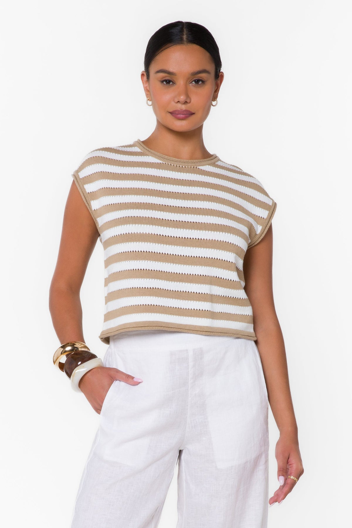 Woman wearing the Abree Optic White Stripe Sweater, a tan and white striped short-sleeve knit top.
